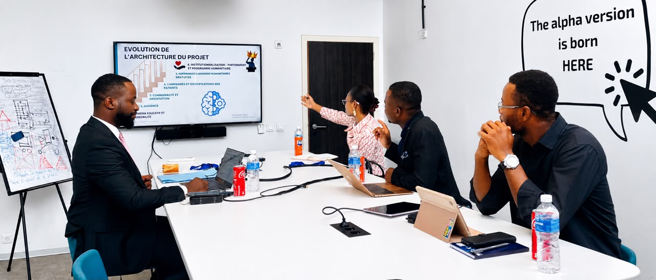The MaxilloHope Africa team meeting around a table to work on the project’s development